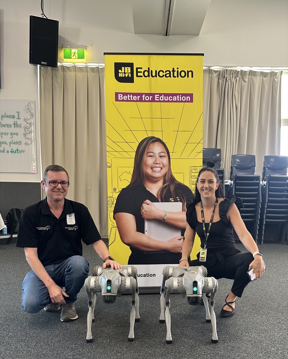 Adrian Tyson with JB Hi-Fi Education and two quadruped robots