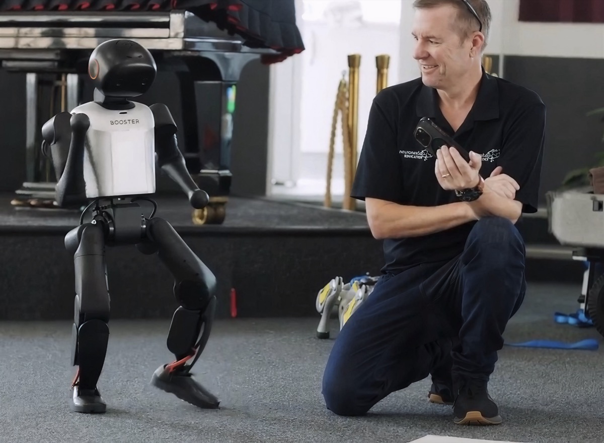 Adrian Tyson operating a Booster humanoid robot