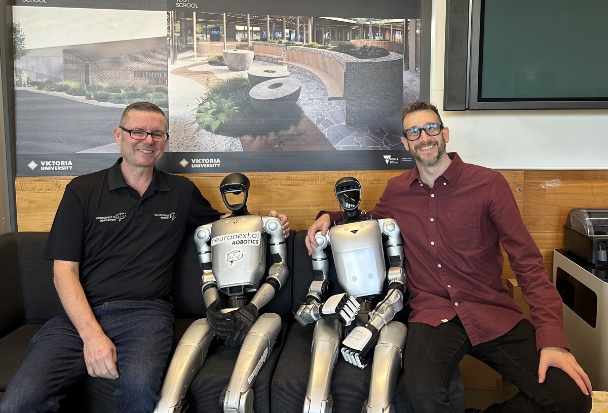 Adrian Tyson with humanoid robots at Brimbank Tech School